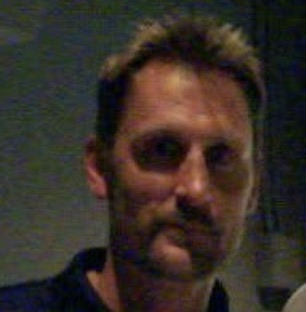 Brent Barry looking toward the camera at an indoor event