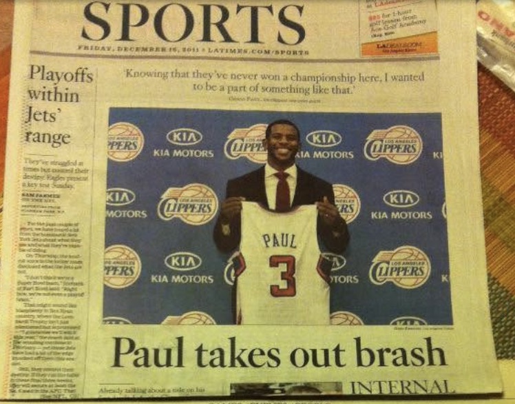 Los Angeles Times sports front page showing Chris Paul holding a Clippers jersey after joining the team