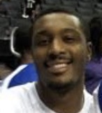Craig Smith smiling courtside at an arena
