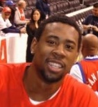 A young DeAndre Jordan in Clippers warmups, smiling toward the camera