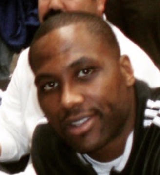 Elton Brand smiling toward the camera at an indoor event