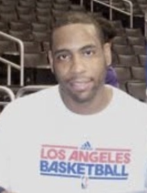 Rasual Butler seated in arena stands wearing an LA Basketball shirt